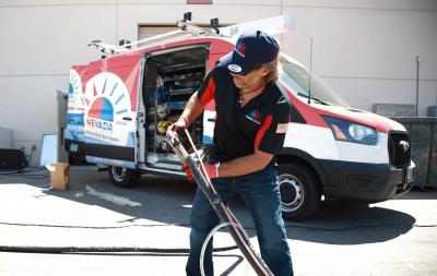 Technician repairing AC unit – MacDonald Ranch